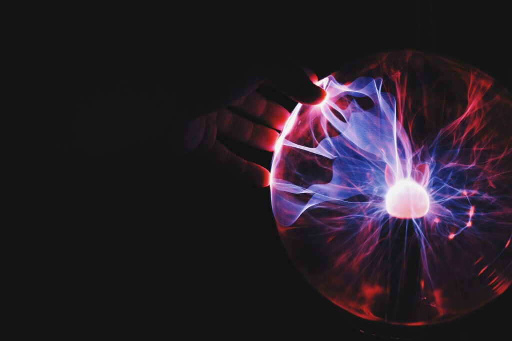 High-tech plasma sphere with colourful electric discharges, representing innovation, science, and brainpower, suitable for educational or technological themes in learning environments.