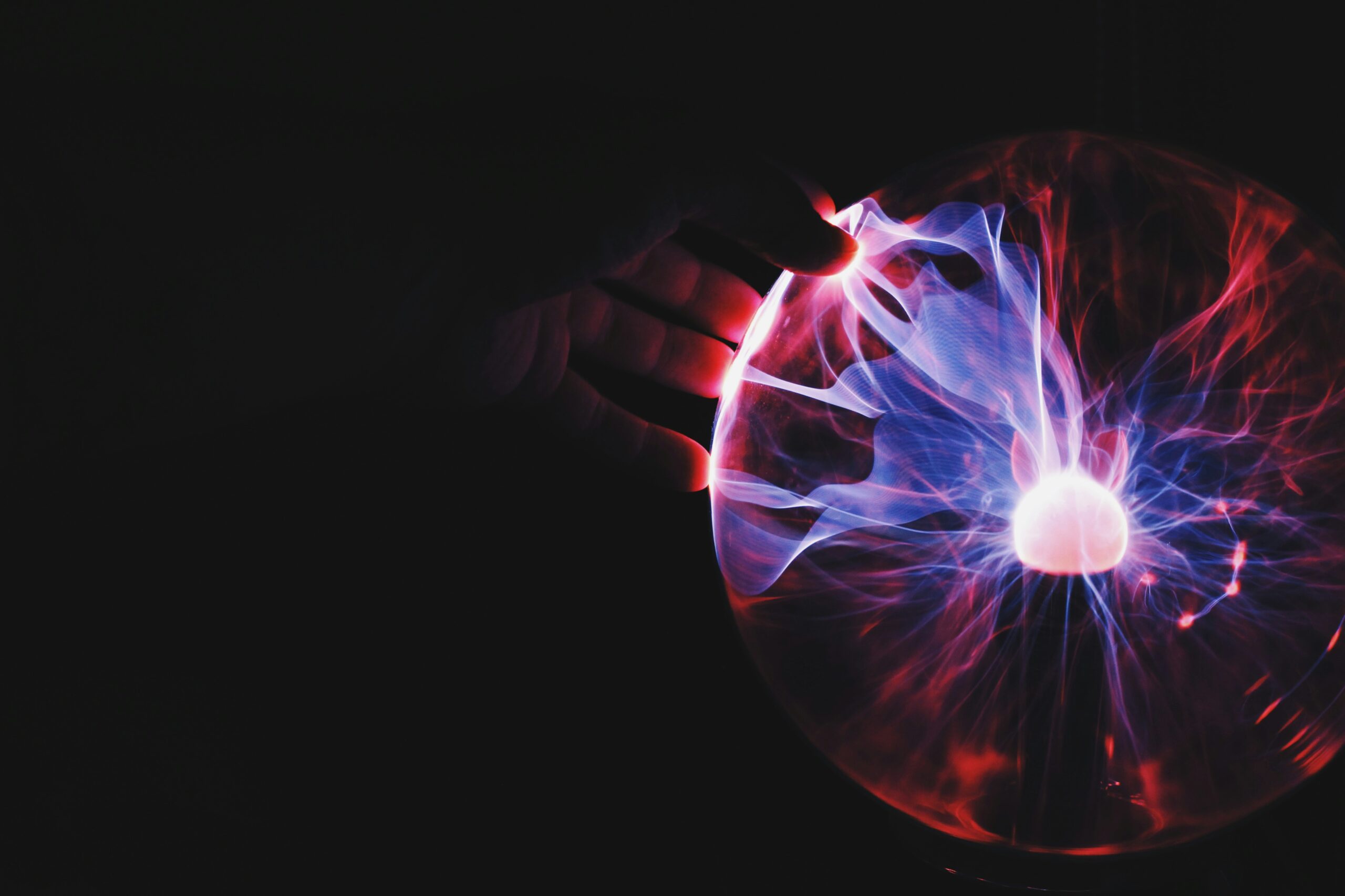 High-tech plasma sphere with colourful electric discharges, representing innovation, science, and brainpower, suitable for educational or technological themes in learning environments.